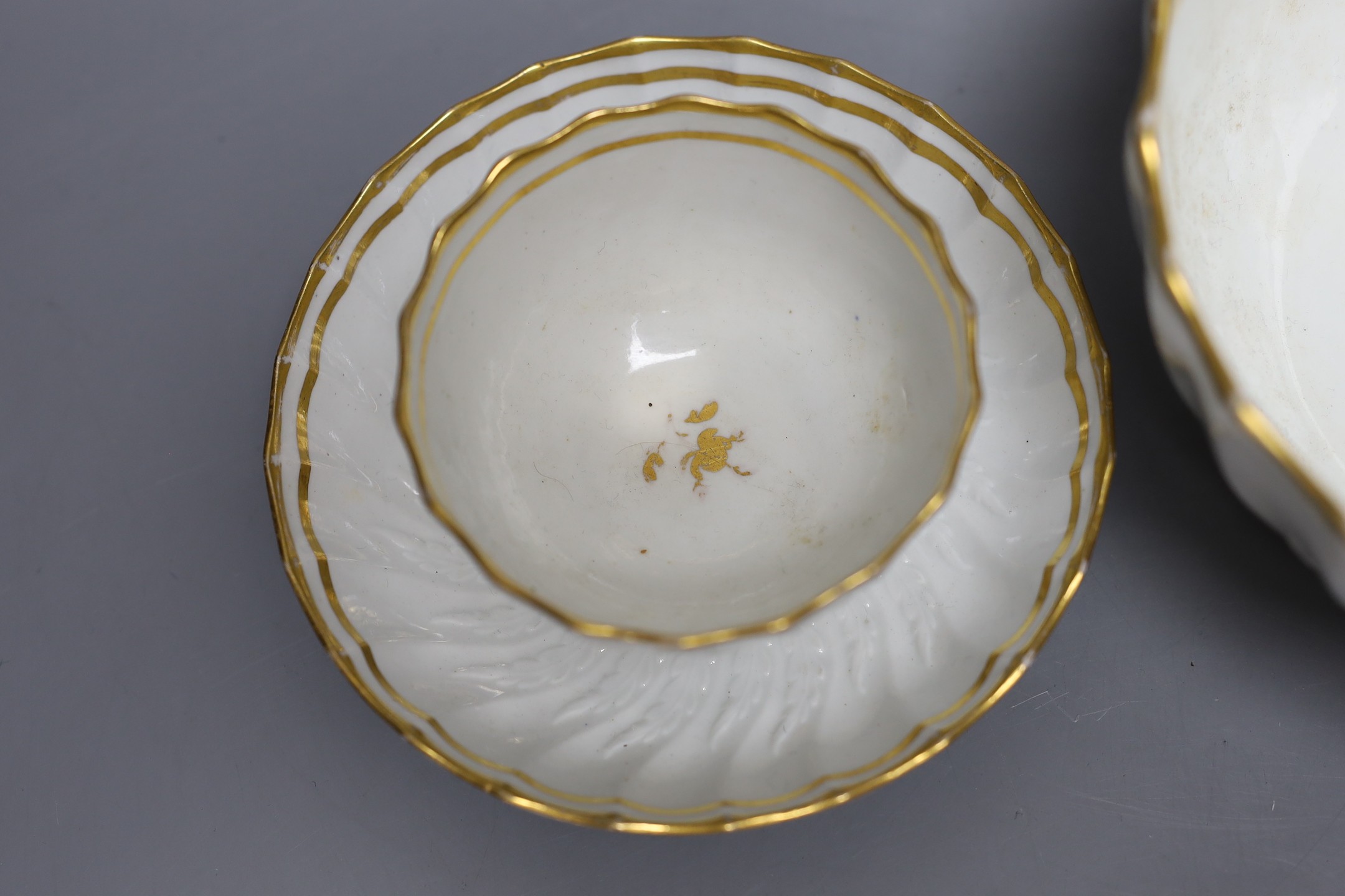 A Neale and Co rare teabowl and saucer and a matching bowl, each piece with acanthus leaf and spirally shanked moulding, the interiors with a gilt floret design, within gilt line borders, for a similar teabowl see Michae